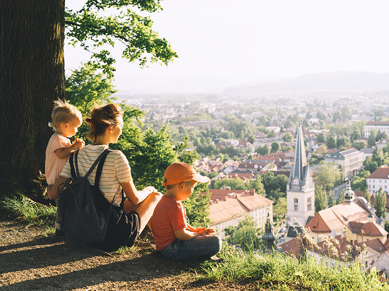 Mom and two kids sitting on hill after appointment at Beyond Wellness, a network of chiropractors and acupuncturists