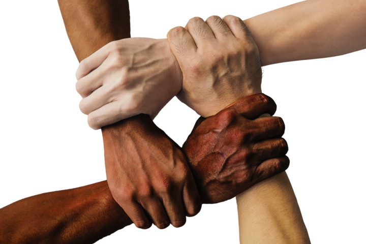 Four hands holding at Beyond Wellness, a network of chiropractors, acupuncturists, and physical therapists