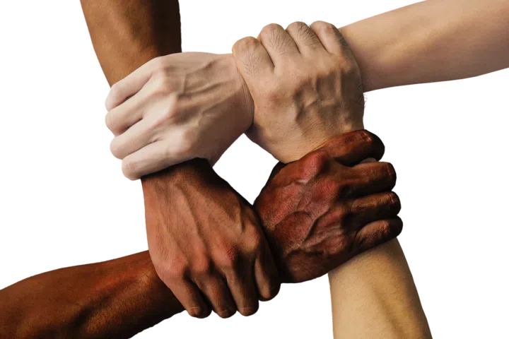 Four hands holding at Beyond Wellness, a network of chiropractors, acupuncturists, and physical therapists
